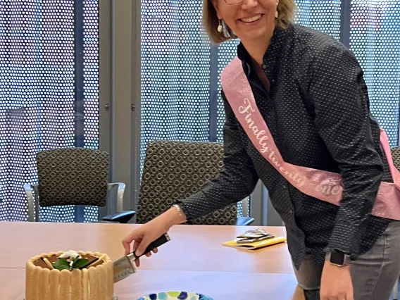 Elisa cutting a birthday cake